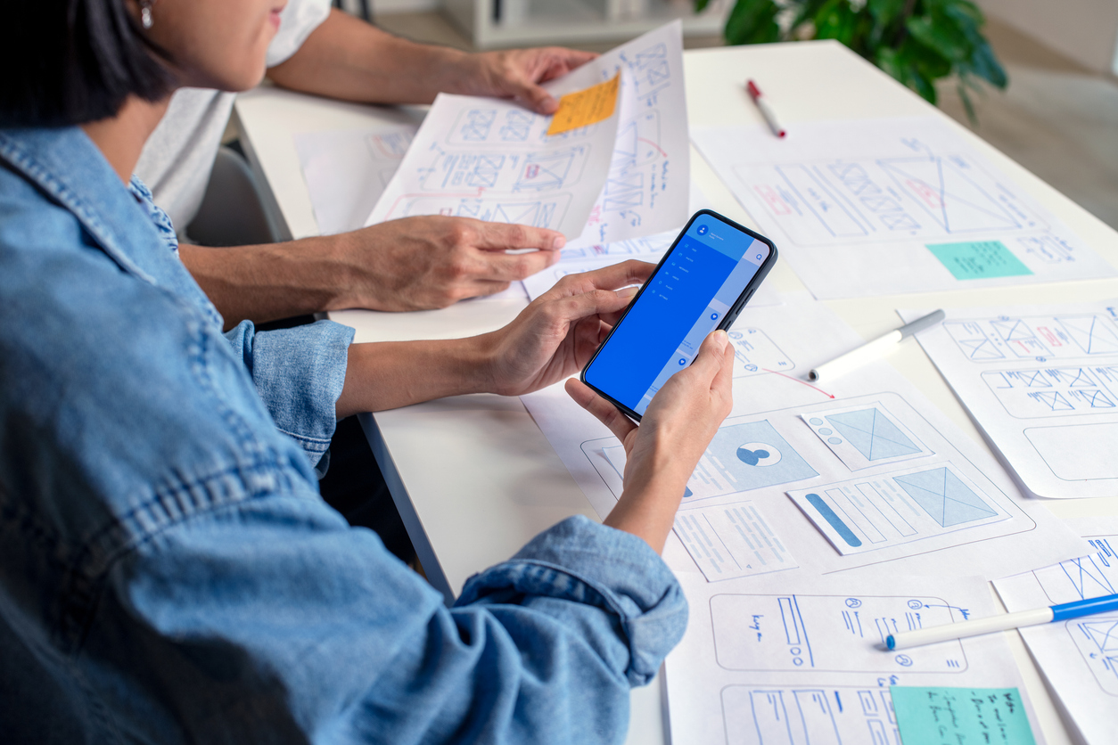 Design team prototyping a mobile application with Leap and HCL Domino, collaborating on UI/UX wireframes and app functionality.